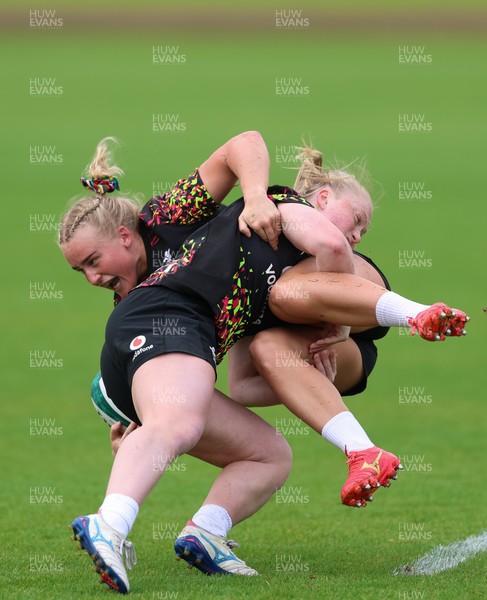 060526 - Wales Women Rugby Training Session - Seren Singleton is tackled by Seren Lockwood during training ahead of the 6 Nations match against Ireland