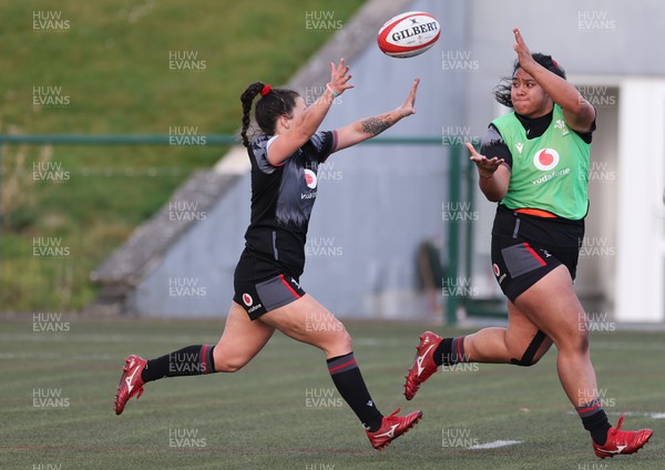 070323 - Wales Women Rugby Training Session - Sisilia Tuipulotu gets the ball past Ffion Lewis during training session