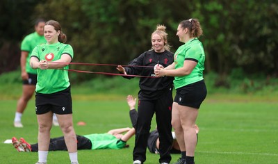071026 Wales Women Rugby Training - Maisie Davies and Gwenllian Pyrs with Erin Lynch, Wales National Squad Physio, during a rugby training session ahead of the WXV matches in Japan