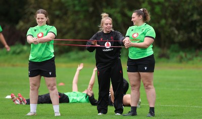 071026 Wales Women Rugby Training - Maisie Davies and Gwenllian Pyrs with Erin Lynch, Wales National Squad Physio, during a rugby training session ahead of the WXV matches in Japan
