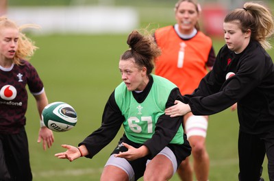 080424 - Wales Women Rugby Training Session - Lleucu George is held by Mollie Wilkinson during a training session ahead of Wales’ Women’s 6 Nations match against Ireland