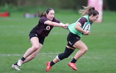 080424 - Wales Women Rugby Training Session - Jasmine Joyce gets away from Nel Metcalfe during a training session ahead of Wales’ Women’s 6 Nations match against Ireland