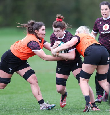 080424 - Wales Women Rugby Training Session - Kate Williams takes on Gwennan Hopkins and Alex Callender during a training session ahead of Wales’ Women’s 6 Nations match against Ireland