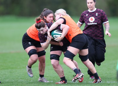 080424 - Wales Women Rugby Training Session - Kate Williams takes on Gwennan Hopkins and Alex Callender during a training session ahead of Wales’ Women’s 6 Nations match against Ireland