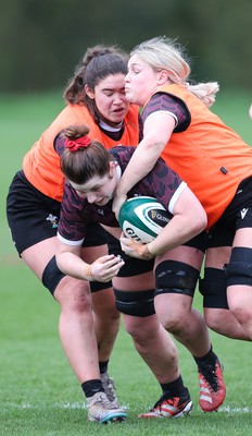 080424 - Wales Women Rugby Training Session - Kate Williams takes on Gwennan Hopkins and Alex Callender during a training session ahead of Wales’ Women’s 6 Nations match against Ireland