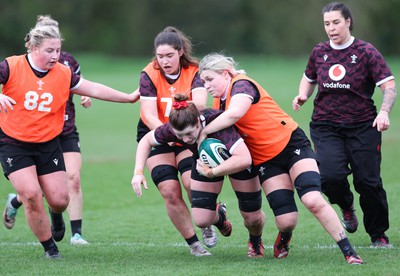 080424 - Wales Women Rugby Training Session - Kate Williams takes on Gwennan Hopkins and Alex Callender during a training session ahead of Wales’ Women’s 6 Nations match against Ireland