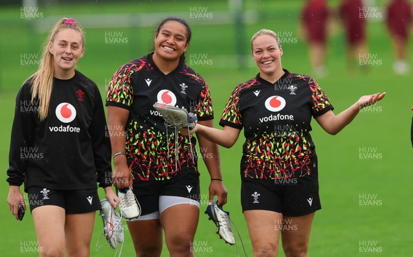 080926 - Wales Women Rugby Training - Hannah Dallavalle, Sisilia Tuipulotu and Kelsey Jones during a rugby session ahead of the WXV Series of matches