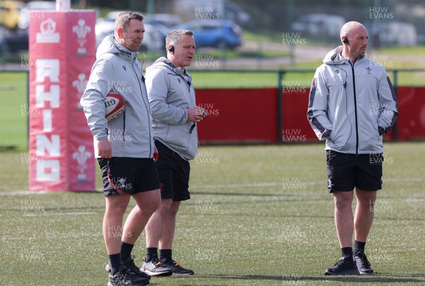 130423 - Wales Women Rugby Training - Wales head coach Ioan Cunningham, left with attack coach Shaun Connor and forwards coach Mike Hill during training ahead of the TicTok Women’s 6 Nations match against England 