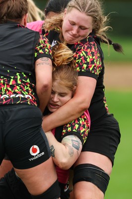 140426 - Wales Women Rugby Training - Bethan Lewis is held by Alaw Pyrs during a rugby training session ahead of the Women’s 6 Nations match against France