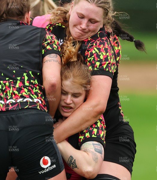 140426 - Wales Women Rugby Training - Bethan Lewis is held by Alaw Pyrs during a rugby training session ahead of the Women’s 6 Nations match against France