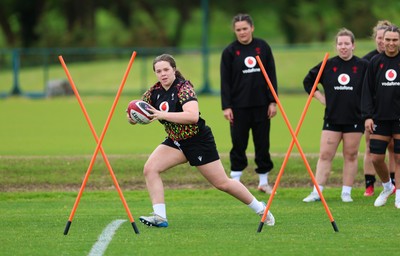 140526 - Wales Women Rugby Training - Maisie Davies warms up during a rugby training session ahead of their final Women’s 6 Nations match against Italy