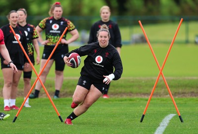 140526 - Wales Women Rugby Training - Katherine Baverstock warms up during a rugby training session ahead of their final Women’s 6 Nations match against Italy