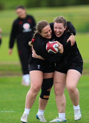 140526 - Wales Women Rugby Training - Jenni Scoble and Elan Jones warm up during a rugby training session ahead of their final Women’s 6 Nations match against Italy