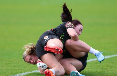 140526 - Wales Women Rugby Training - Freya Bell is tackled by Sian Jones during a rugby training session ahead of their final Women’s 6 Nations match against Italy