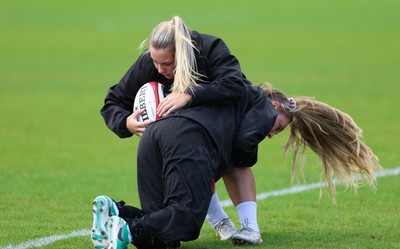 140526 - Wales Women Rugby Training - Kelsie Webster is tackled by Hannah Dallavalle during a rugby training session ahead of their final Women’s 6 Nations match against Italy