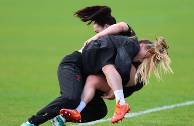 140526 - Wales Women Rugby Training - Sian Jones is tackled by Hannah Dallavalle during a rugby training session ahead of their final Women’s 6 Nations match against Italy