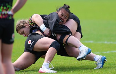 140526 - Wales Women Rugby Training - Jenni Scoble is tackled by Jenna De Vera during a rugby training session ahead of their final Women’s 6 Nations match against Italy