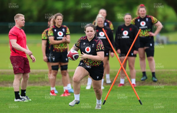 140526 - Wales Women Rugby Training - Maisie Davies warms up during a rugby training session ahead of their final Women’s 6 Nations match against Italy