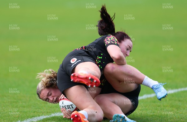 140526 - Wales Women Rugby Training - Freya Bell is tackled by Sian Jones during a rugby training session ahead of their final Women’s 6 Nations match against Italy