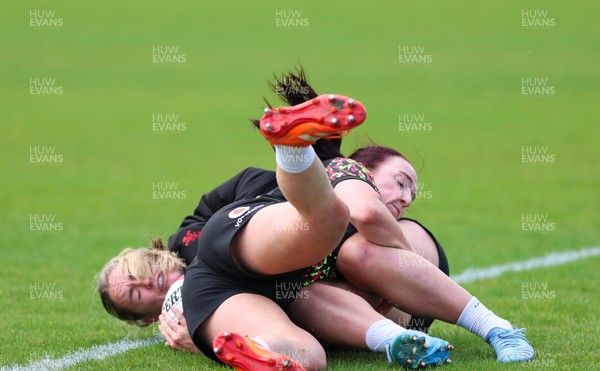 140526 - Wales Women Rugby Training - Freya Bell is tackled by Sian Jones during a rugby training session ahead of their final Women’s 6 Nations match against Italy