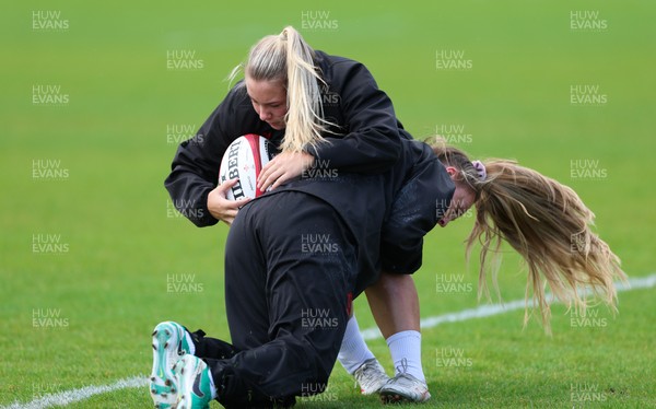 140526 - Wales Women Rugby Training - Kelsie Webster is tackled by Hannah Dallavalle during a rugby training session ahead of their final Women’s 6 Nations match against Italy