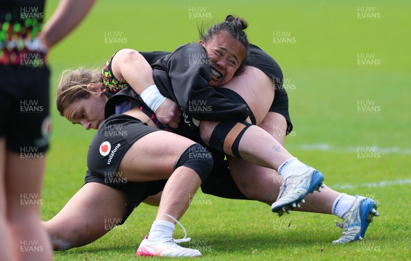 140526 - Wales Women Rugby Training - Jenni Scoble is tackled by Jenna De Vera during a rugby training session ahead of their final Women’s 6 Nations match against Italy