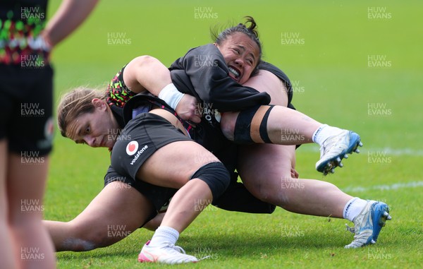 140526 - Wales Women Rugby Training - Jenni Scoble is tackled by Jenna De Vera during a rugby training session ahead of their final Women’s 6 Nations match against Italy