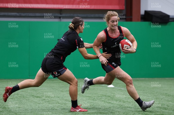 140923 - Wales Women Rugby Training Session - Lisa Neumann hands off Jazz Joyce during training session