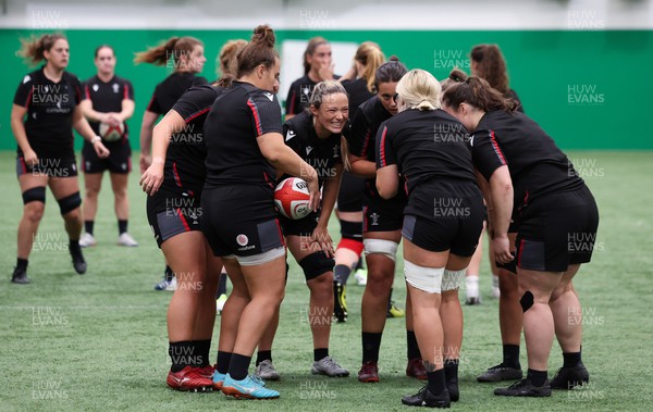 140923 - Wales Women Rugby Training Session - Alisha Butchers raises a smile as the forwards gather together during training session