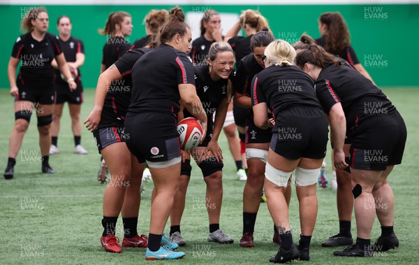 140923 - Wales Women Rugby Training Session - Alisha Butchers raises a smile as the forwards gather together during training session