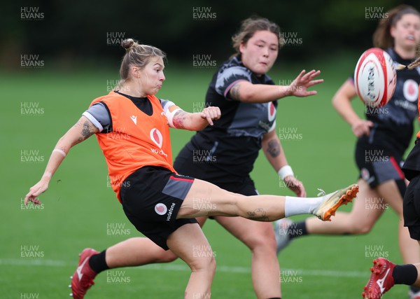 140923 - Wales Women Rugby Training Session - Keira Bevan kicks as Cana Williams closes in during training session