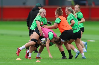 140926 Wales Women Rugby Training Session - Alex Callender tackles Natalia John during a rugby training session ahead of the WXV matches against South Africa and USA
