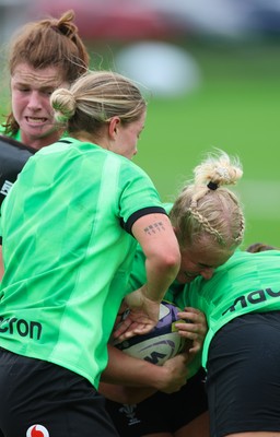 140926 Wales Women Rugby Training Session - Seren Singleton is tackled during a rugby training session ahead of the WXV matches against South Africa and USA