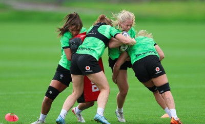 140926 Wales Women Rugby Training Session - Seren Lockwood is tackled during a rugby training session ahead of the WXV matches against South Africa and USA