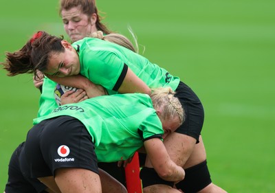 140926 Wales Women Rugby Training Session - Branwen Metcalfe is tackled during a rugby training session ahead of the WXV matches against South Africa and USA
