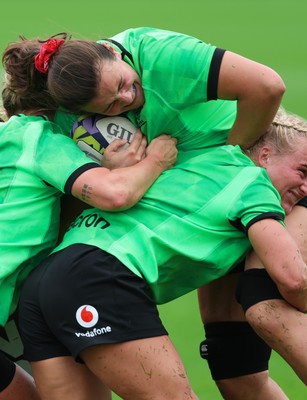 140926 Wales Women Rugby Training Session - Branwen Metcalfe is tackled during a rugby training session ahead of the WXV matches against South Africa and USA