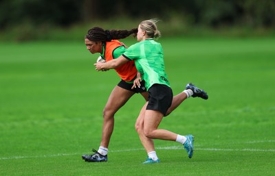 140926 Wales Women Rugby Training Session - Nia Fajeyisan takes on Amy Williams during a rugby training session ahead of the WXV matches against South Africa and USA