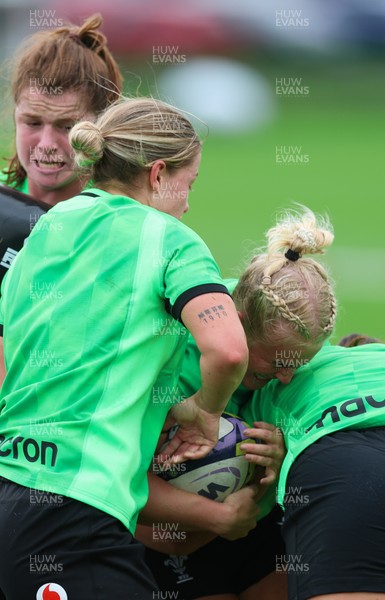 140926 Wales Women Rugby Training Session - Seren Singleton is tackled during a rugby training session ahead of the WXV matches against South Africa and USA