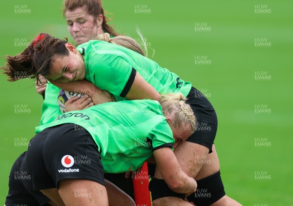 140926 Wales Women Rugby Training Session - Branwen Metcalfe is tackled during a rugby training session ahead of the WXV matches against South Africa and USA