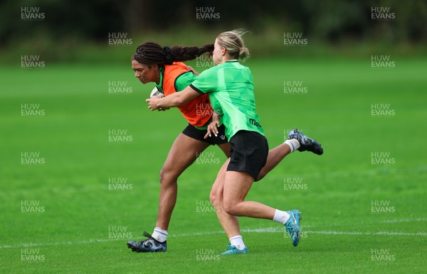 140926 Wales Women Rugby Training Session - Nia Fajeyisan takes on Amy Williams during a rugby training session ahead of the WXV matches against South Africa and USA