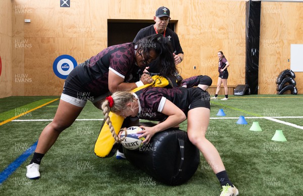 141023 - Wales Women Training Session -  Sisilia Tuipulotu and Hannah Jones are watched by Ioan Cunningham during a rugby training session at the NZCIS in Wellington