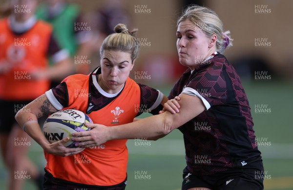 141023 - Wales Women Training Session -  Keira Bevan is held by Alex Callender during a rugby training session at the NZCIS in Wellington