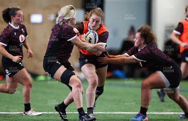 141023 - Wales Women Training Session -  Lisa Neumann takes on Alex Callender and Lleucu George during a rugby training session at the NZCIS in Wellington