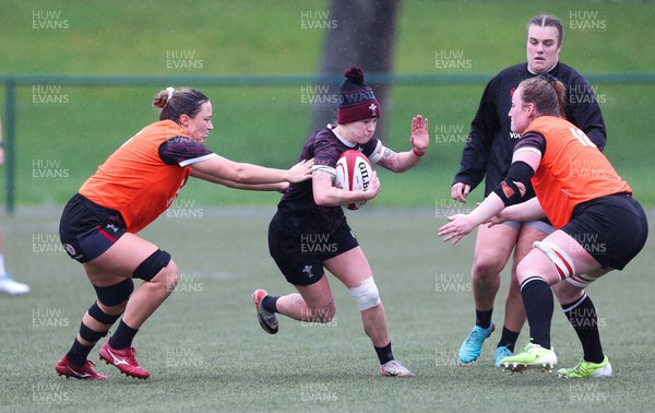 150224 - Wales Women Extended Squad Training session - Keira Bevan gets past Alisha Butchers and Abbie Fleming during training session as preparations get under way for the Women’s 6 Nations