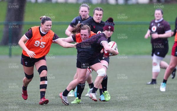 150224 - Wales Women Extended Squad Training session - Keira Bevan gets past Alisha Butchers and Abbie Fleming during training session as preparations get under way for the Women’s 6 Nations