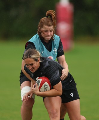 150725 - Wales Women Rugby training - Courtney Keight is held by Kate Williams during a training session ahead of their two match tour against Australia