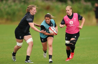 150725 - Wales Women Rugby training - Kayleigh Powell gets past Alaw Pyrs during a training session ahead of their two match tour against Australia