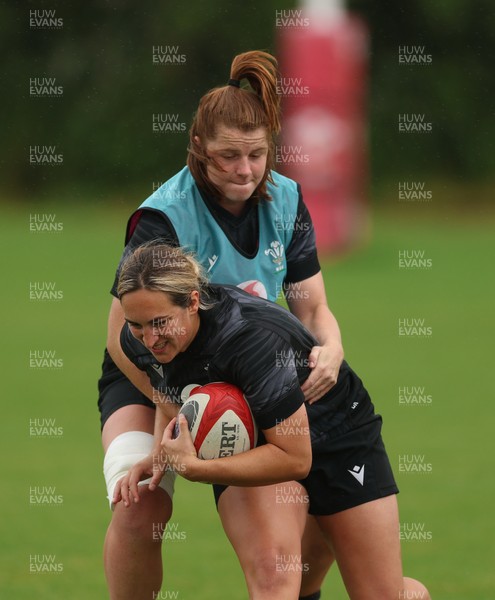 150725 - Wales Women Rugby training - Courtney Keight is held by Kate Williams during a training session ahead of their two match tour against Australia