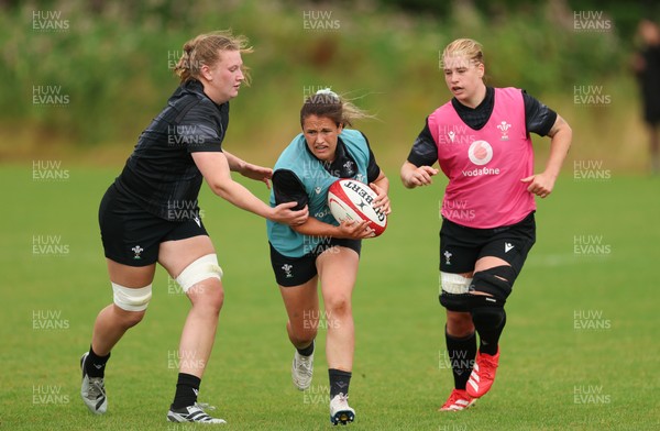 150725 - Wales Women Rugby training - Kayleigh Powell gets past Alaw Pyrs during a training session ahead of their two match tour against Australia