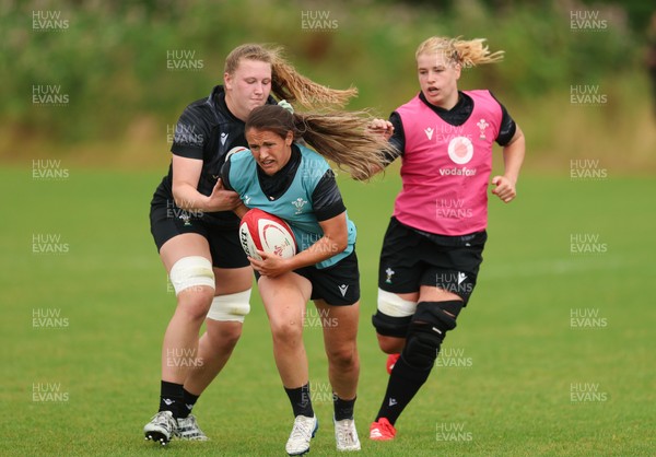150725 - Wales Women Rugby training - Kayleigh Powell gets past Alaw Pyrs during a training session ahead of their two match tour against Australia
